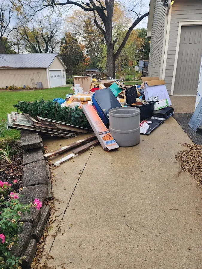 Dumpster being loaded with debris for 12 Yard Dumpster Rental in Ford City